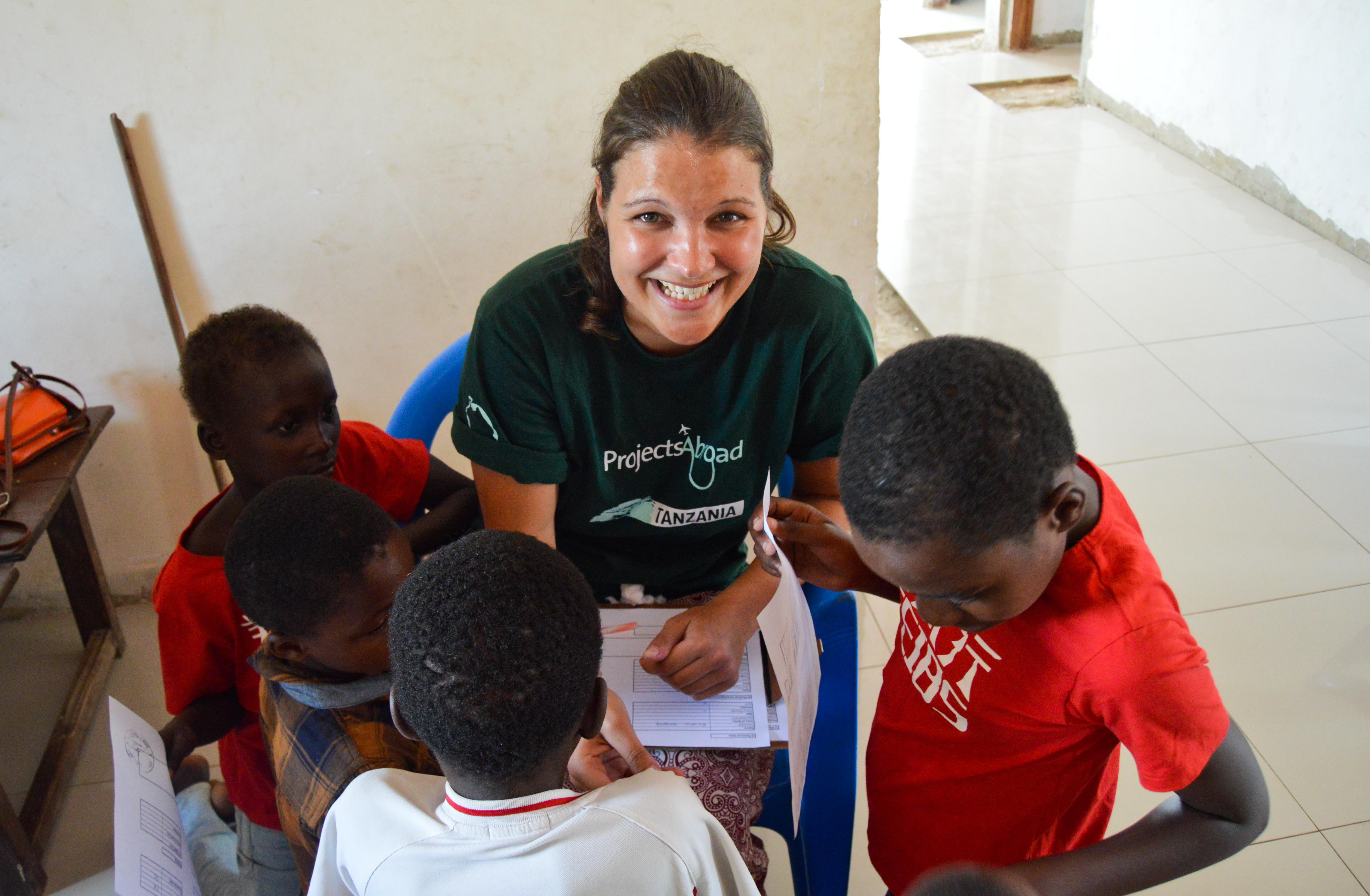An intern with Projects Abroad screening children at a medical outreach during her nursing internship in Tanzania. Female intern from Projects Abroad is pictured screening children during her nursing internship in Tanzania.